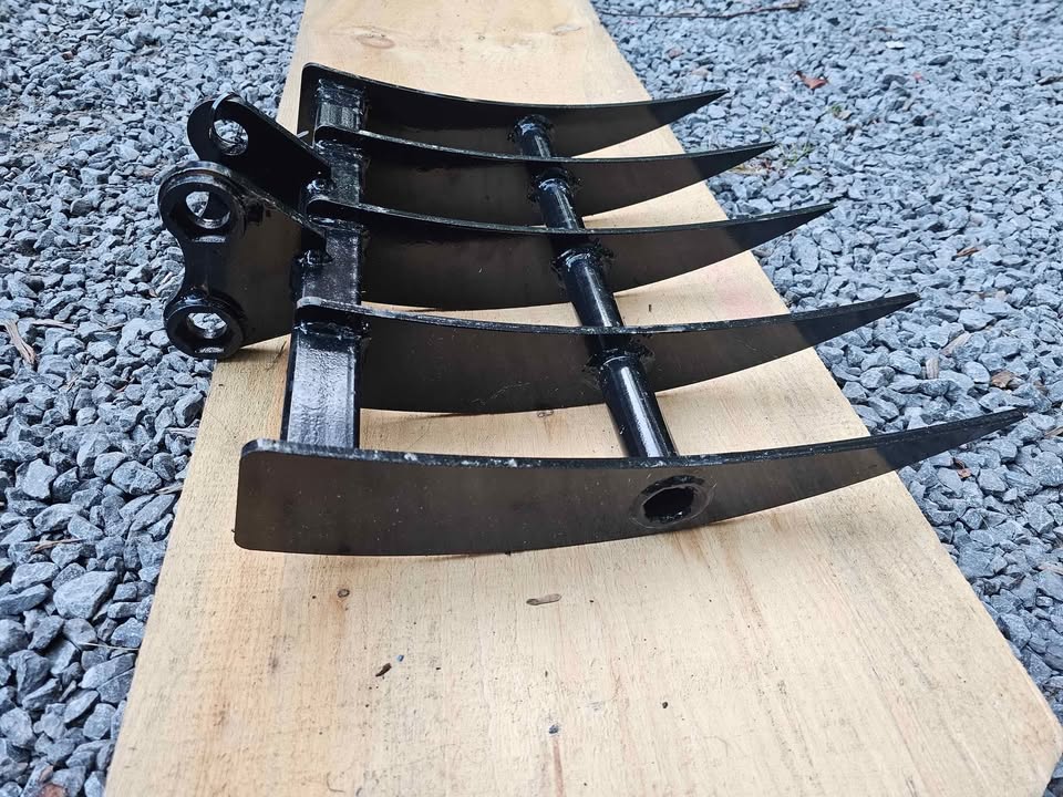 Mini-excavator rake attachment